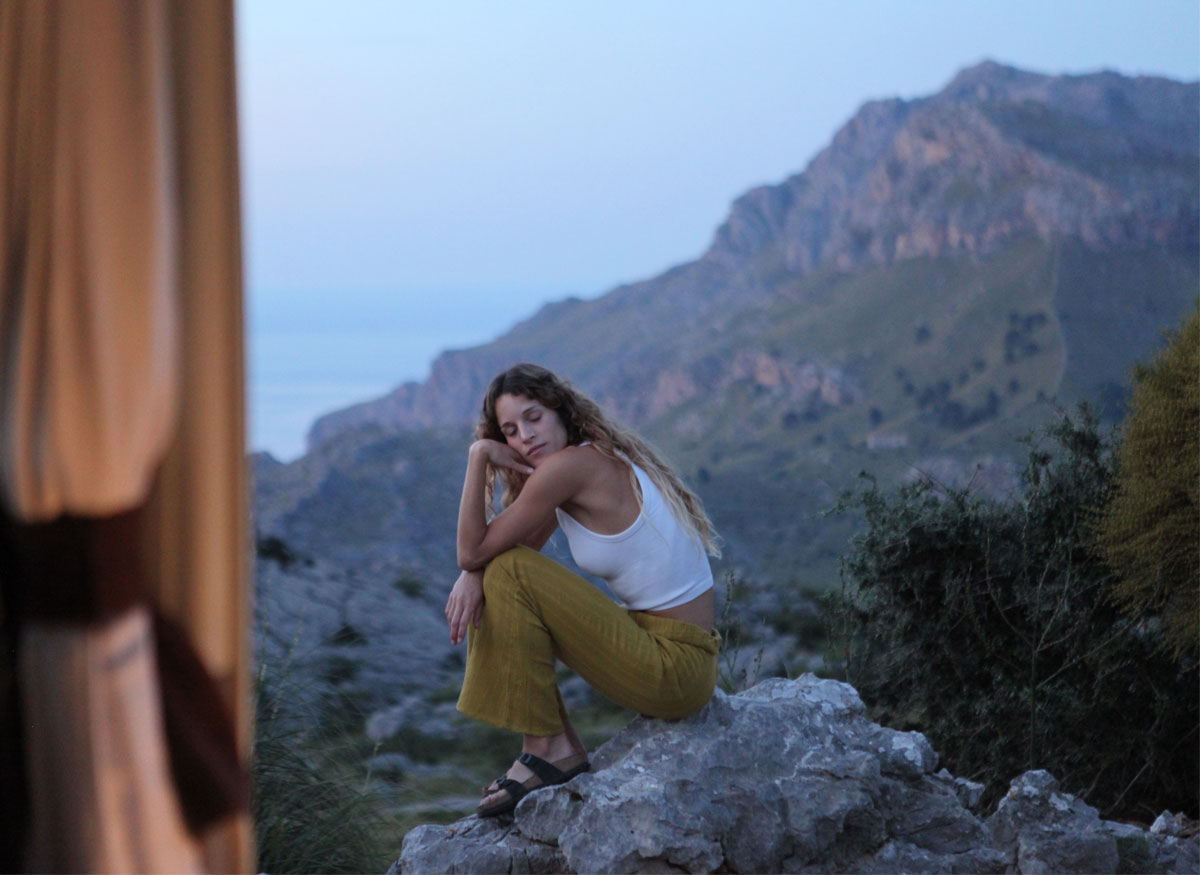 person sitting in mountains